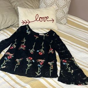 Embroidered black lace blouse with bell sleeves.